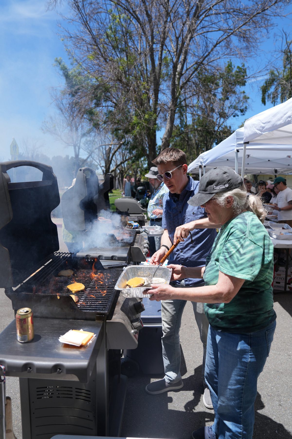 Volunteers flipping burgers at the grill