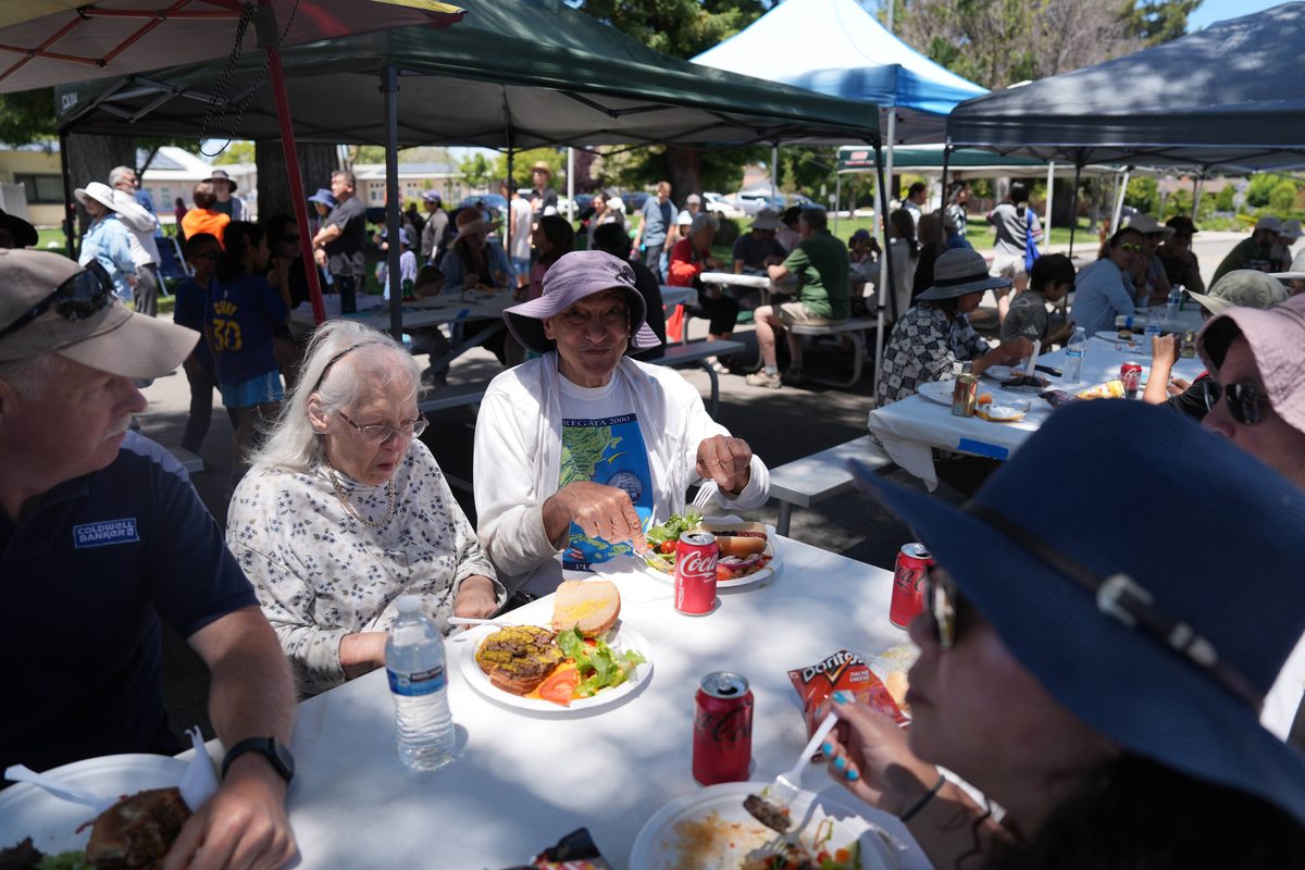 Neighbors sharing a meal together at the block party